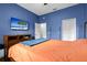 Comfortable bedroom with stylish decor, including a large bed, dresser, and modern television at 9075 Waterash N Ln, Pinellas Park, FL 33782