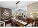 Elegant dining space boasting hardwood floors and sophisticated decor with views into the living room at 9075 Waterash N Ln, Pinellas Park, FL 33782