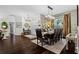 Open dining room with hardwood floors, modern lighting, and elegant furnishings at 9075 Waterash N Ln, Pinellas Park, FL 33782