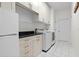 Well-organized laundry room with sleek countertops, storage cabinets and modern washer and dryer at 9075 Waterash N Ln, Pinellas Park, FL 33782