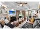 Inviting living room with dark wood floors, fireplace, and seamless transition to kitchen at 9075 Waterash N Ln, Pinellas Park, FL 33782