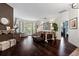 Bright and airy living room showcasing hardwood floors and access to the outdoors through glass doors at 9075 Waterash N Ln, Pinellas Park, FL 33782