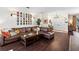Comfortable living room featuring hardwood floors, a large sectional couch, and elegant décor at 9075 Waterash N Ln, Pinellas Park, FL 33782