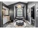 Luxurious main bathroom features a modern bathtub, vanity, chandelier, and elegant gray color scheme at 9075 Waterash N Ln, Pinellas Park, FL 33782