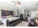 Spacious main bedroom with dark wood floors and tray ceiling leads to main bathroom with white trim at 9075 Waterash N Ln, Pinellas Park, FL 33782