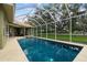 Sparkling screened-in pool with patio, landscaped backyard and mature trees for shade at 9075 Waterash N Ln, Pinellas Park, FL 33782