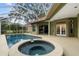 Inviting backyard pool with spa featuring screened enclosure and spacious patio area at 9075 Waterash N Ln, Pinellas Park, FL 33782