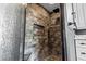 Modern tiled shower with glass door, rainfall shower head, and built-in niche at 9075 Waterash N Ln, Pinellas Park, FL 33782