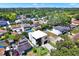 Aerial view of neighborhood with a modern two-story home, well-kept lawns, and mature trees at 908 W Fribley St, Tampa, FL 33603