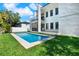 Exterior of home showcasing a modern design, pristine pool and manicured lawn at 908 W Fribley St, Tampa, FL 33603
