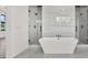 Bathroom featuring a tub and two glass enclosed showers with marble tile at 908 W Fribley St, Tampa, FL 33603