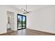 Bedroom featuring hardwood floors and sliding glass door to outside at 908 W Fribley St, Tampa, FL 33603