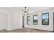 A bright bedroom with hardwood floors, modern light fixture and windows at 908 W Fribley St, Tampa, FL 33603