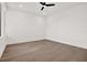 Minimalist bedroom with hardwood floors, a ceiling fan, and a large window providing natural light at 908 W Fribley St, Tampa, FL 33603