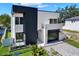 Striking home exterior with modern design, clean lines, large windows, and a well-kept lawn at 908 W Fribley St, Tampa, FL 33603