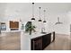 Open concept kitchen with a central island, wine cooler, and hardwood floors connecting to the living area at 908 W Fribley St, Tampa, FL 33603