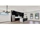 Sleek, modern kitchen with stainless steel appliances, a large island with pendant lighting, and hardwood floors at 908 W Fribley St, Tampa, FL 33603
