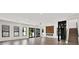 Spacious living room with hardwood floors, a modern fireplace, and large glass doors leading to the backyard at 908 W Fribley St, Tampa, FL 33603