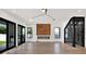 Modern living room with a sleek fireplace, wine storage, hardwood floors, and glass doors to an outdoor space at 908 W Fribley St, Tampa, FL 33603