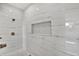 A shower with marble tile and hexagon tile on shower floor at 908 W Fribley St, Tampa, FL 33603