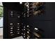 View of sleek, contemporary wine room with ample bottle storage and display on dark walls at 908 W Fribley St, Tampa, FL 33603