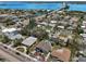 Aerial view of a waterfront neighborhood featuring well-maintained homes, mature trees, and a picturesque bridge at 931 Gulf Blvd, Belleair Beach, FL 33786