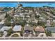 Expansive aerial view of a residential neighborhood showcasing a bay, bridge, and well-maintained landscaping at 931 Gulf Blvd, Belleair Beach, FL 33786