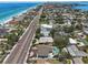 Breathtaking aerial view of homes near a pristine beach with clear blue water and coastal road at 931 Gulf Blvd, Belleair Beach, FL 33786