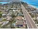 Expansive aerial view of homes with swimming pools near a beautiful coastline and roadways at 931 Gulf Blvd, Belleair Beach, FL 33786