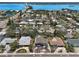 Aerial view of a charming neighborhood with beautiful homes, lush trees, and a bridge over a scenic waterway at 931 Gulf Blvd, Belleair Beach, FL 33786