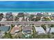 Aerial view of beachfront homes, highlighting direct access to a beautiful white sandy beach at 931 Gulf Blvd, Belleair Beach, FL 33786