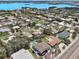 Wide aerial view showing charming homes with pools nestled in a lush neighborhood near the coast at 931 Gulf Blvd, Belleair Beach, FL 33786