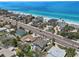 Stunning aerial shot showcasing beachfront properties with turquoise ocean views and nearby road at 931 Gulf Blvd, Belleair Beach, FL 33786