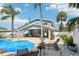 Beautiful backyard with a pool, patio, and lush tropical landscaping under a sunny sky at 931 Gulf Blvd, Belleair Beach, FL 33786