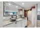 This bathroom offers a double sink vanity with granite counters, and modern vessel sinks with lots of storage at 931 Gulf Blvd, Belleair Beach, FL 33786