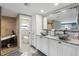 The bathroom features a double sink vanity, modern faucets, granite counters, and walk-in shower with tub at 931 Gulf Blvd, Belleair Beach, FL 33786