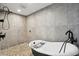 Relax in this luxurious bathroom featuring modern fixtures, stylish tile work, and a freestanding soaking tub at 931 Gulf Blvd, Belleair Beach, FL 33786