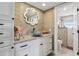 Charming bathroom featuring colorful glass vessel sinks and a unique floral mirror at 931 Gulf Blvd, Belleair Beach, FL 33786