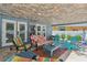 Cozy covered patio offering a relaxing seating area, perfect for enjoying outdoor living at 931 Gulf Blvd, Belleair Beach, FL 33786