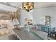 Elegant dining area with unique table, decorative lighting, and an open view of the staircase at 931 Gulf Blvd, Belleair Beach, FL 33786