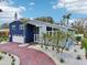 Beautiful two-story home featuring a red brick driveway and meticulously landscaped front yard with palm trees at 931 Gulf Blvd, Belleair Beach, FL 33786