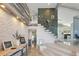 Amazing foyer features a floating staircase with a unique octopus sculpture, wood accents and views of the kitchen at 931 Gulf Blvd, Belleair Beach, FL 33786