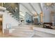 Elegant foyer featuring a unique staircase with an octopus sculpture, complemented by open living spaces and modern design at 931 Gulf Blvd, Belleair Beach, FL 33786