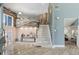 Expansive foyer with a modern staircase, artistic details, and an open layout leading to well-lit living spaces and kitchen at 931 Gulf Blvd, Belleair Beach, FL 33786
