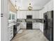 Contemporary kitchen with white cabinets, stainless steel appliances, and sleek countertops at 931 Gulf Blvd, Belleair Beach, FL 33786