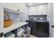 Functional laundry room featuring modern washer and dryer, ample storage space, and bright, clean design at 931 Gulf Blvd, Belleair Beach, FL 33786