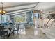 Bright, open living room featuring vaulted ceilings, modern decor, and large windows with lush outdoor views at 931 Gulf Blvd, Belleair Beach, FL 33786