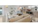 Open-concept living area featuring a stone fireplace, comfortable seating, and a bright, welcoming atmosphere at 931 Gulf Blvd, Belleair Beach, FL 33786