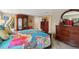 This bedroom has wood floors, vintage furniture, and closet, creating a warm and inviting space at 931 Gulf Blvd, Belleair Beach, FL 33786