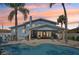 Gorgeous outdoor space with covered patio seating, outdoor furniture, and a stunning in ground swimming pool at 931 Gulf Blvd, Belleair Beach, FL 33786